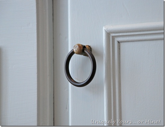 Vintage ring pulls on gray credenza