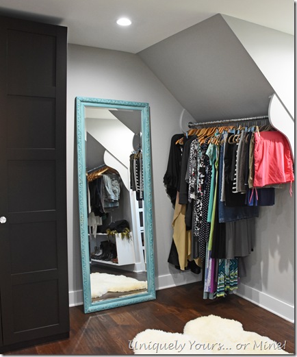 Slanted ceiling hanging space in renovated closet turned dressing room