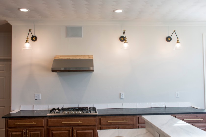 kitchen focal wall articulating pendants full tile wall